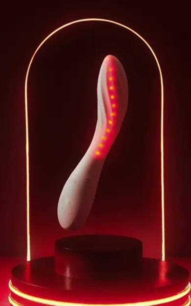 LELO MONA Spectra white intimate massager illuminated in red