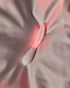 LELO MONA Spectra white intimate massager with red LEDs on fabric