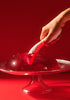 Hand holding the waterproof LELO MONA Spectra with red LEDs
